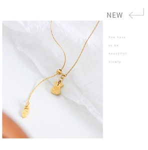 Detail of golden bunny and carrot pendant with adjustable slider chain link