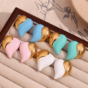 Macro view of heart-shaped earrings in colorful enamel and 18K gold-plated stainless steel
