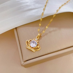 Elegant gold hollow crown necklace with sparkling zircon pendant on a silk background