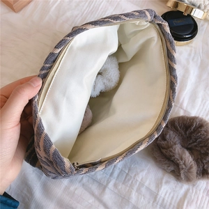 Detail view of large capacity chenille cosmetic bag with striped texture and soft lining