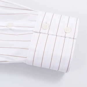 Detailed close-up of striped poplin shirt cuff with round corner and white buttons