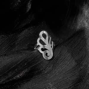 Spider lily pattern titanium steel ring with silver finish on black fabric background