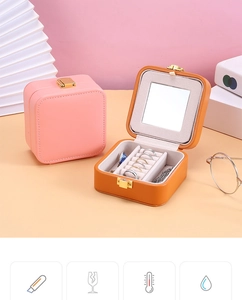 Detail of pink and orange PU leather jewelry boxes with built-in mirrors and ring slots