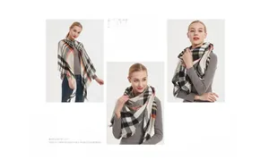 Detail of plaid cashmere-like scarf with fringe edges in soft beige, orange and black