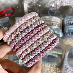 Detailed macro view of woven high-elastic hair ties in various Morandi colors set