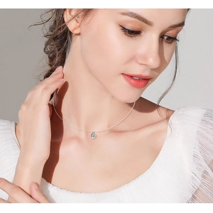 Elegant s925 silver necklace with sparkling teardrop moissanite pendant on a model