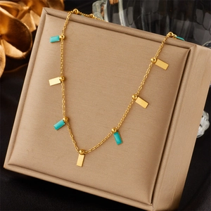 Retro gold necklace with star moon oval turquoise pendant on a beige jewelry box