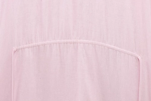 Detail of pink linen blend fabric showing woven texture and durable double-stitch seams