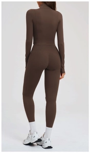 Detail of coffee brown yoga set featuring a slim-fit zip jacket and leggings with side pocket