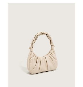 Detailed view of the pleated beige cloud bag made of high-quality soft PU leather material