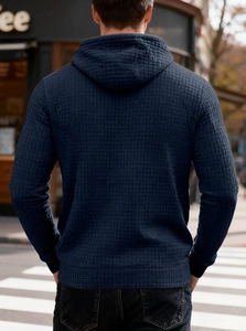 Detailed back view of navy blue waffle texture hoodie for men in urban street setting