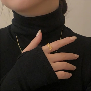 Close-up of elegant gold bow ring in S925 sterling silver worn on model finger