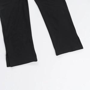 Detail view of the side split hem on black slim-fit halter neck jumpsuit for women