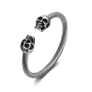 Vintage woven stainless steel bangle featuring double skull heads in silver finish