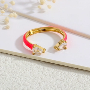 Detail of neon pink enamel ring with pear-shaped cubic zirconia on 18K gold band