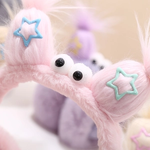 Cute pink plush winter earmuffs with funny eyes and stars for women and children