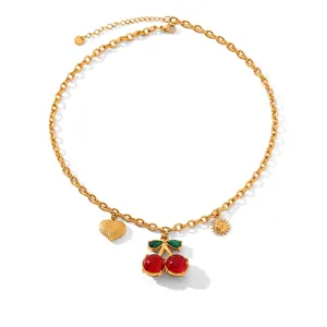 Detail of gold chain necklace with cherry, heart, and sun charms with size specs