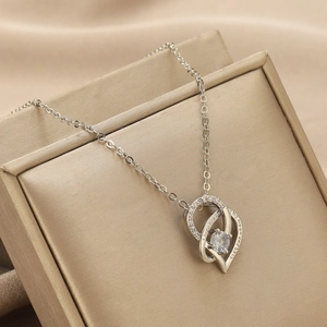 Macro shot of silver heart necklace with crystal and I love you to the moon engraving