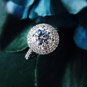 Exquisite halo engagement ring with brilliant round zircon and paved band in silver finish
