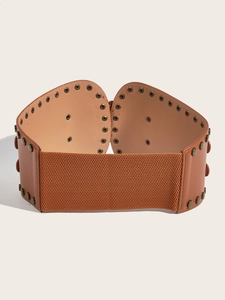 Macro shot of brown retro cinch belt with metal grommets and textured elastic band
