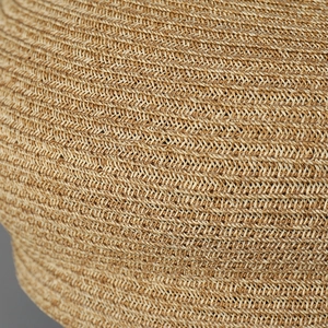 Macro close-up showing the intricate twill weave texture of the natural straw sun hat