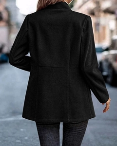 Close-up of women's black longline blazer showing premium herringbone weave texture and fit