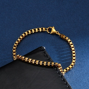 Macro shot of minimalist gold stainless steel box chain with polished lobster clasp