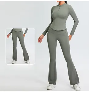 Detail view of the stand-up collar and quarter-zip on this slim-fit yoga set in smoke green