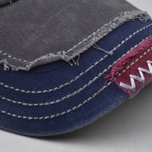 Close-up of distressed cotton New York baseball cap with vintage patchwork and zig-zag stitching