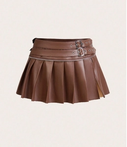 Detail of brown PU leather pleated mini skirt with belt buckles and zipper accents