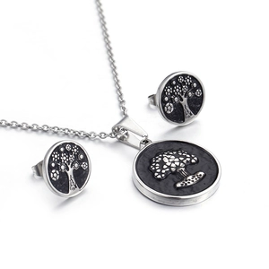 Silver tree of life jewelry set featuring coin pendant necklace and matching stud earrings