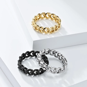 Detailed view of polished chain link rings in gold, silver, and matte black finishes
