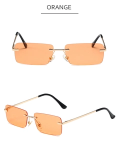 Detail of orange rimless rectangular sunglasses with gold metal frame and spring hinges