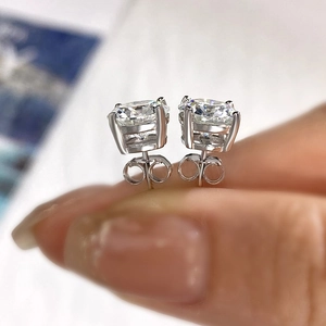 Macro shot of 925 sterling silver moissanite stud earrings in four-prong setting