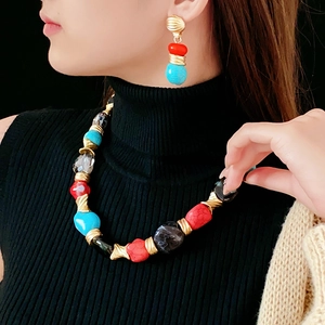 Macro detail of vintage irregular geometric necklace and earring set with colorful beads