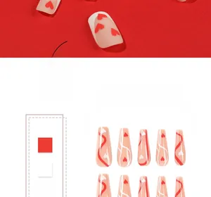 Macro detail of red heart and white swirl patterns on long coffin press-on nails