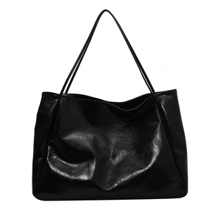 Minimalist black soft leather large tote bag with glossy finish and slim shoulder straps