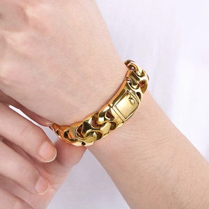 Close-up of a wide gold-plated punk dragon chain bracelet for men in stainless steel