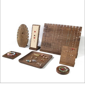 Detail of vintage dark walnut wood jewelry display set with necklace stand and tray