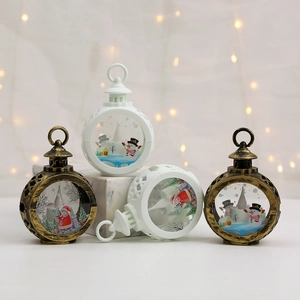 Close-up of bronze and white Christmas lanterns with Santa and snowman scenes