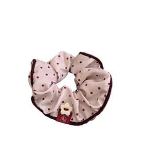 Vintage pink polka dot scrunchie with red trim and premium fabric texture for women