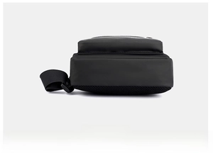 Detail showing the breathable mesh bottom and textured fabric of this black shoulder bag