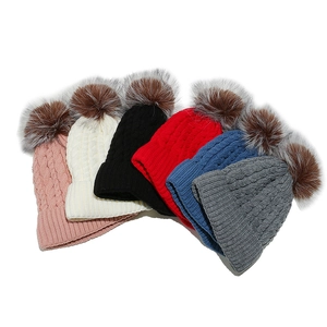 Winter cable knit beanies with faux fur pom-poms in various colors on white background