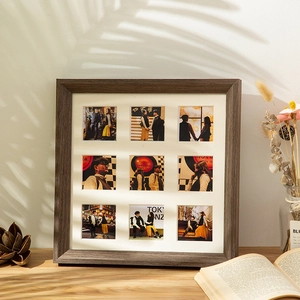 Square dark brown wooden grid photo frame with nine slots and white matting displayed on a desk