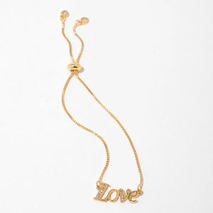 Detail of adjustable gold LOVE bracelet with cubic zirconia accents and slider clasp