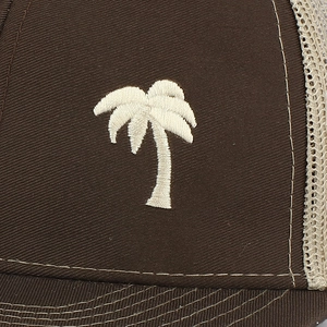 Close-up of white palm tree embroidery on dark brown mesh snapback baseball cap
