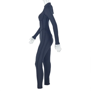 Detail view of black long sleeve jumpsuit with athletic contour stitching on a mannequin