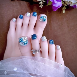 Dark blue cat-eye press-on toenails with silver glitter and 3D rhinestone accents