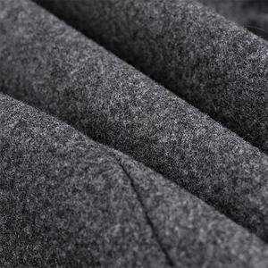 Close-up of thick dark grey wool blend fabric showing high-density fiber texture