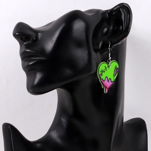 Grape green heart earring with graffiti drip design on a black mannequin model